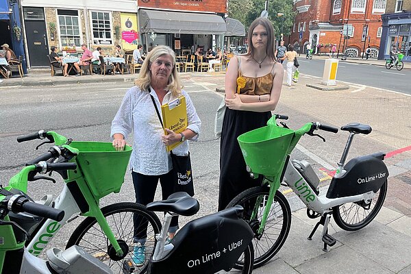 Lib Dem activists with badly parked Lime Bikes